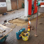 laying ground bricks in petrol station forecourt