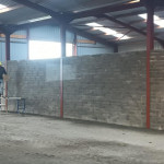 plastering wall in warehouse