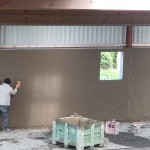 plastering wall in warehouse