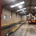 Concrete floor laying in warehouse